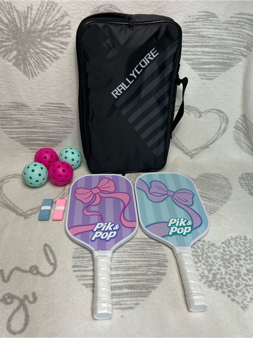 Rallycore pickleball paddle set with pink and blue bow designs